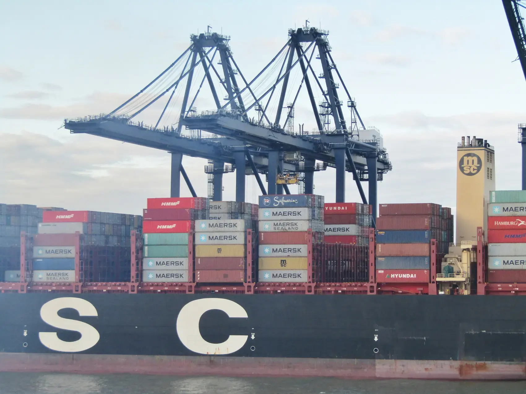 A container ship being loaded by gantry cranes at the Port of Felixstowe