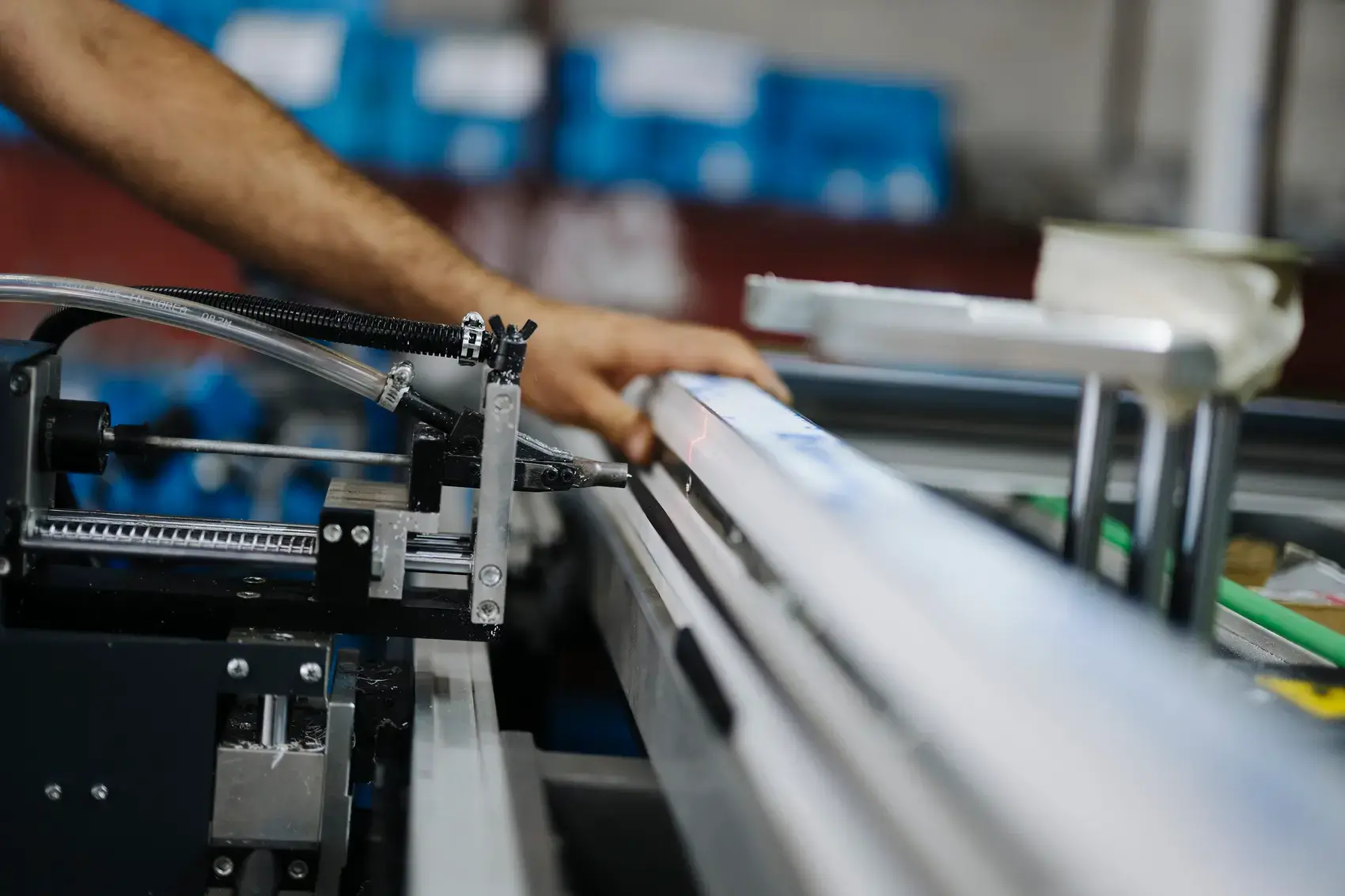 A worker operating machinery on a factory production line