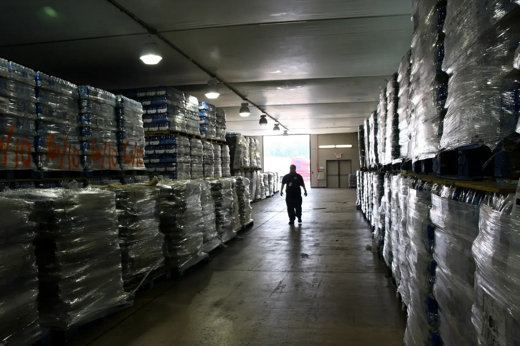 Stacked pallets of stock in a warehouse