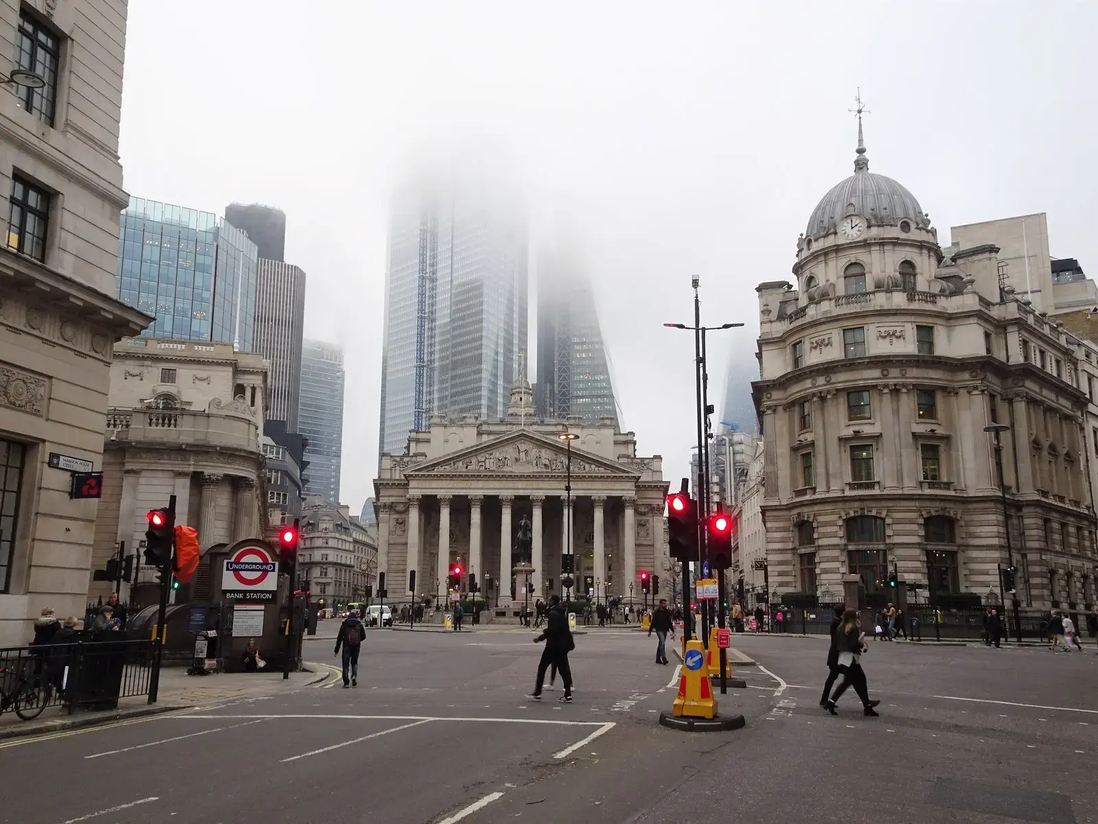 Bank junction in the City of London with the Royal Exchange and office towers in mist